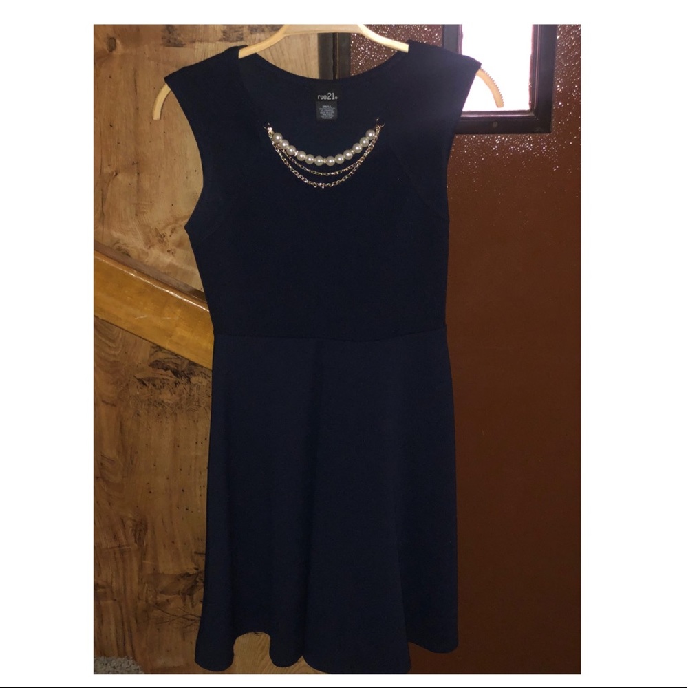 Cute navy blue dress with jewelry attached to it